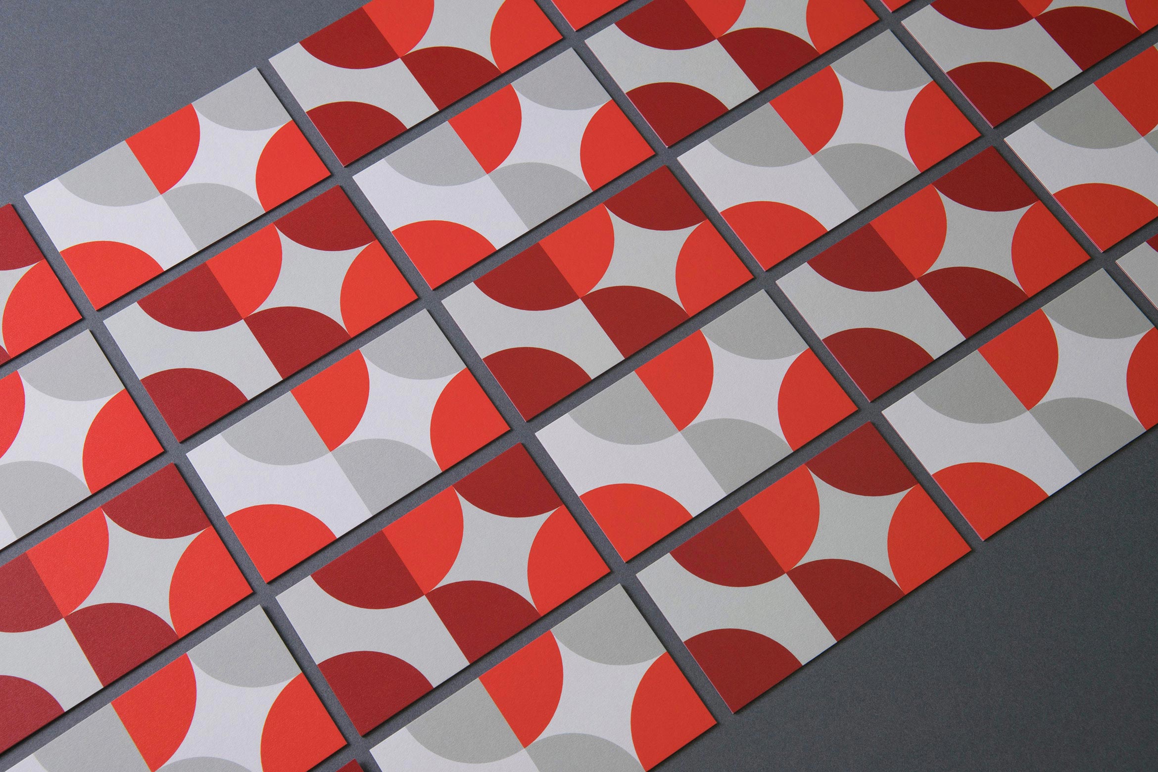 grid of lined up soren west business cards with red and gray dot pattern