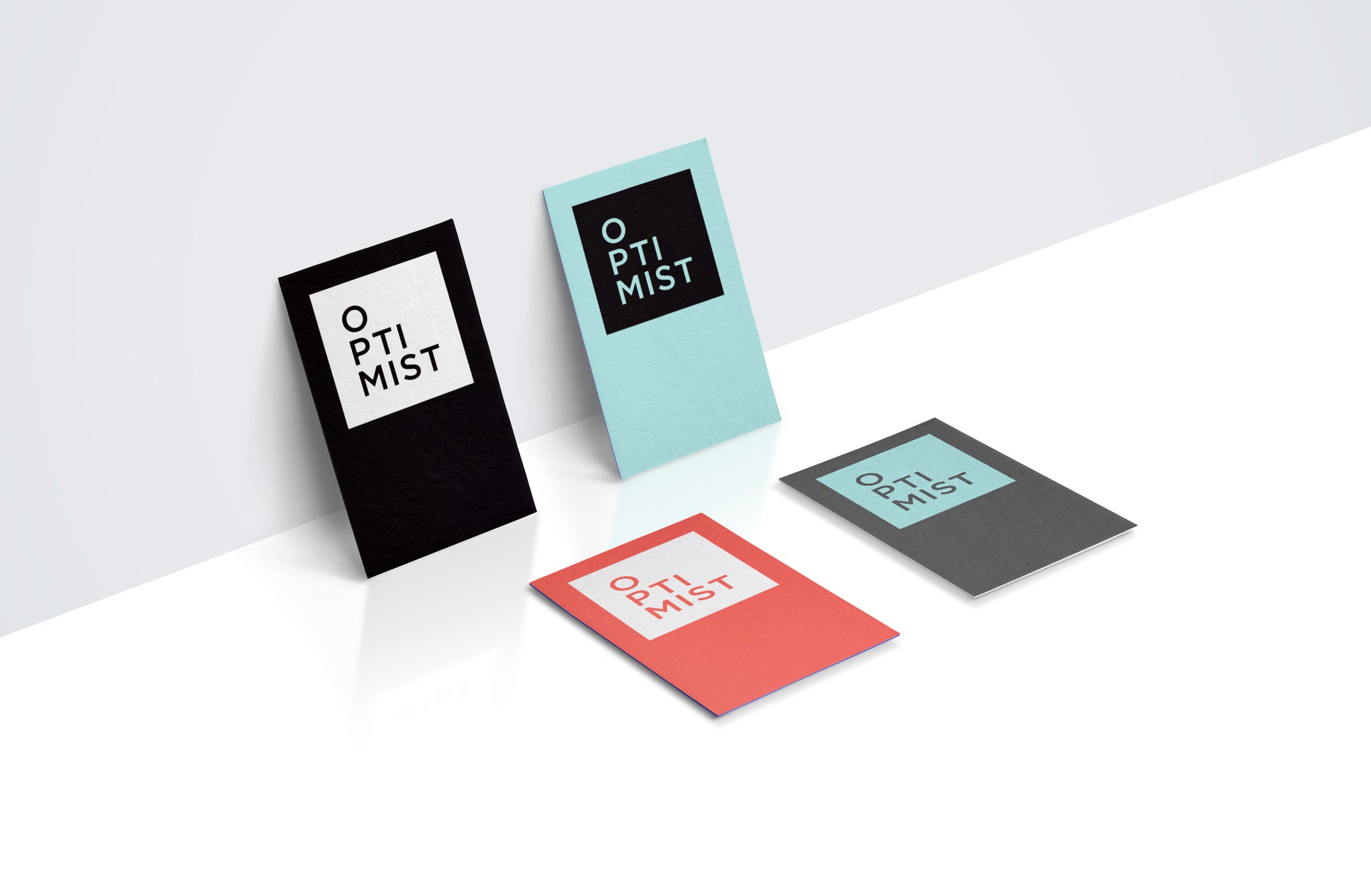 4 business cards with various color combinations for optimist films