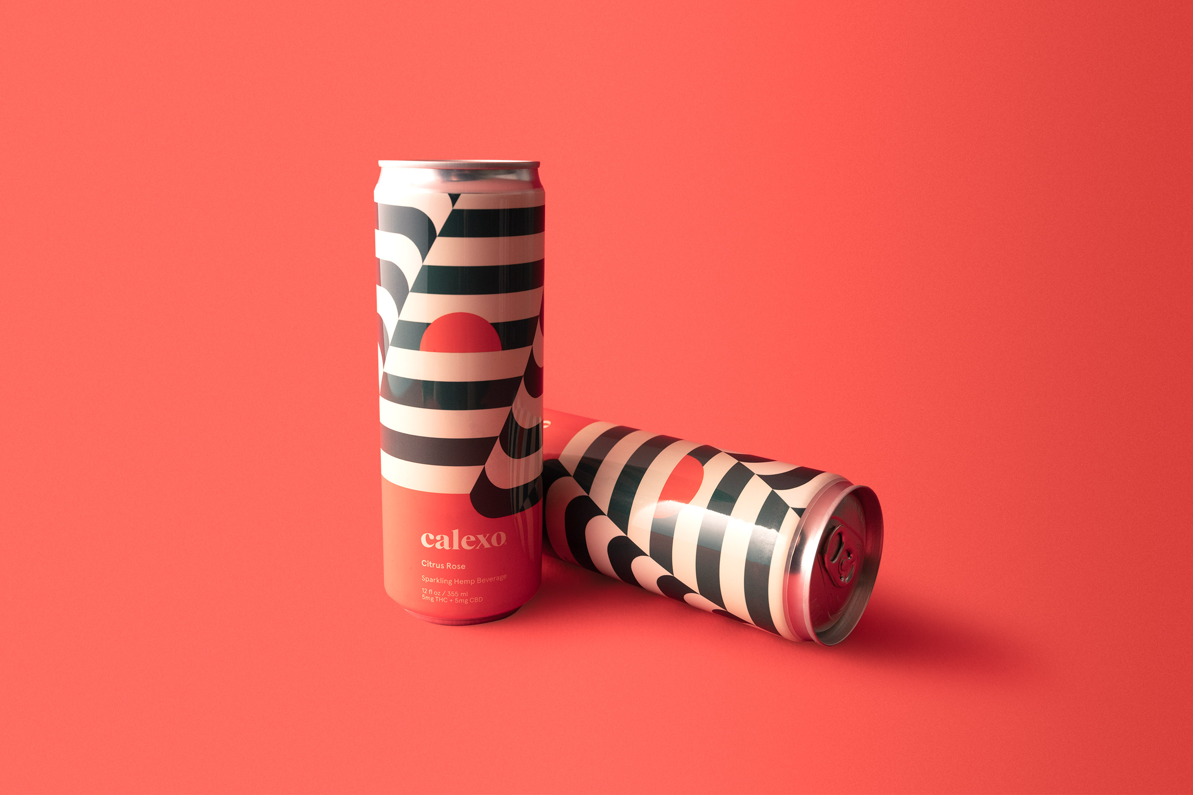 2 calexo citrus rose hemp beverage cans on coral backdrop