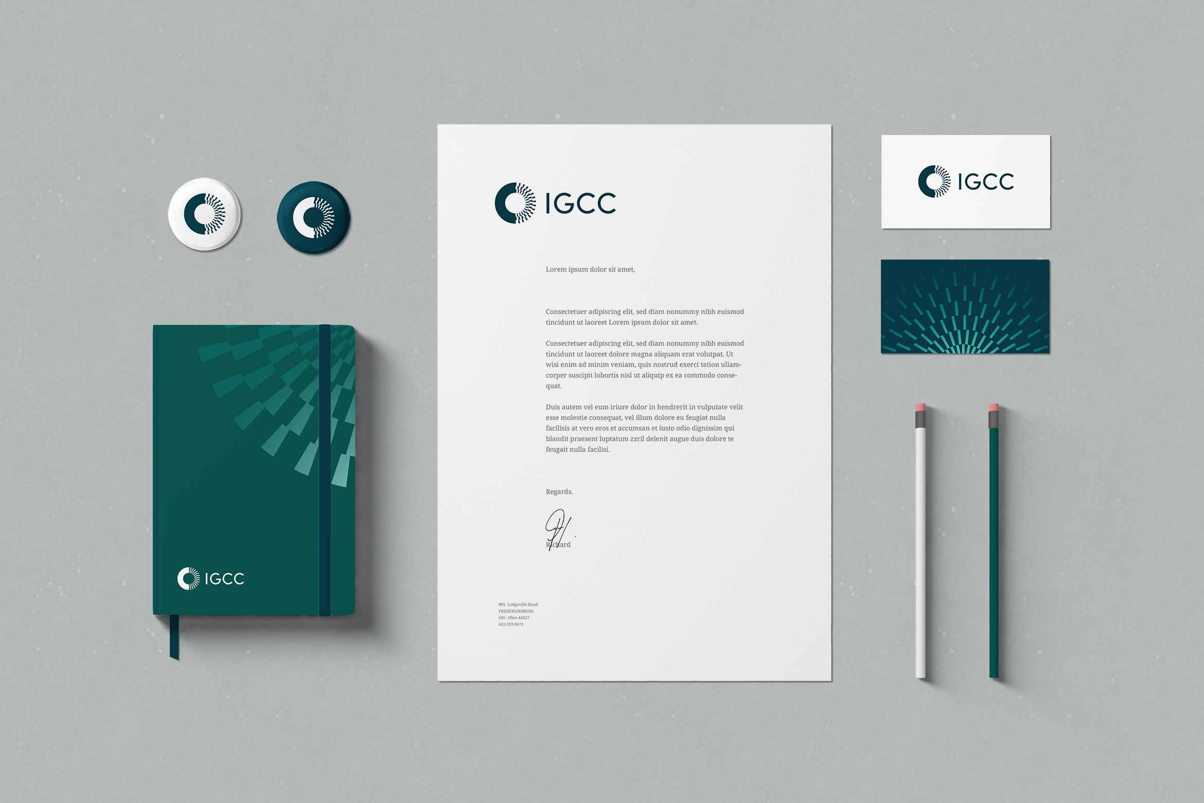 IGCC branded stationery suite with letterhead, business card, pencils, buttons and a notebook