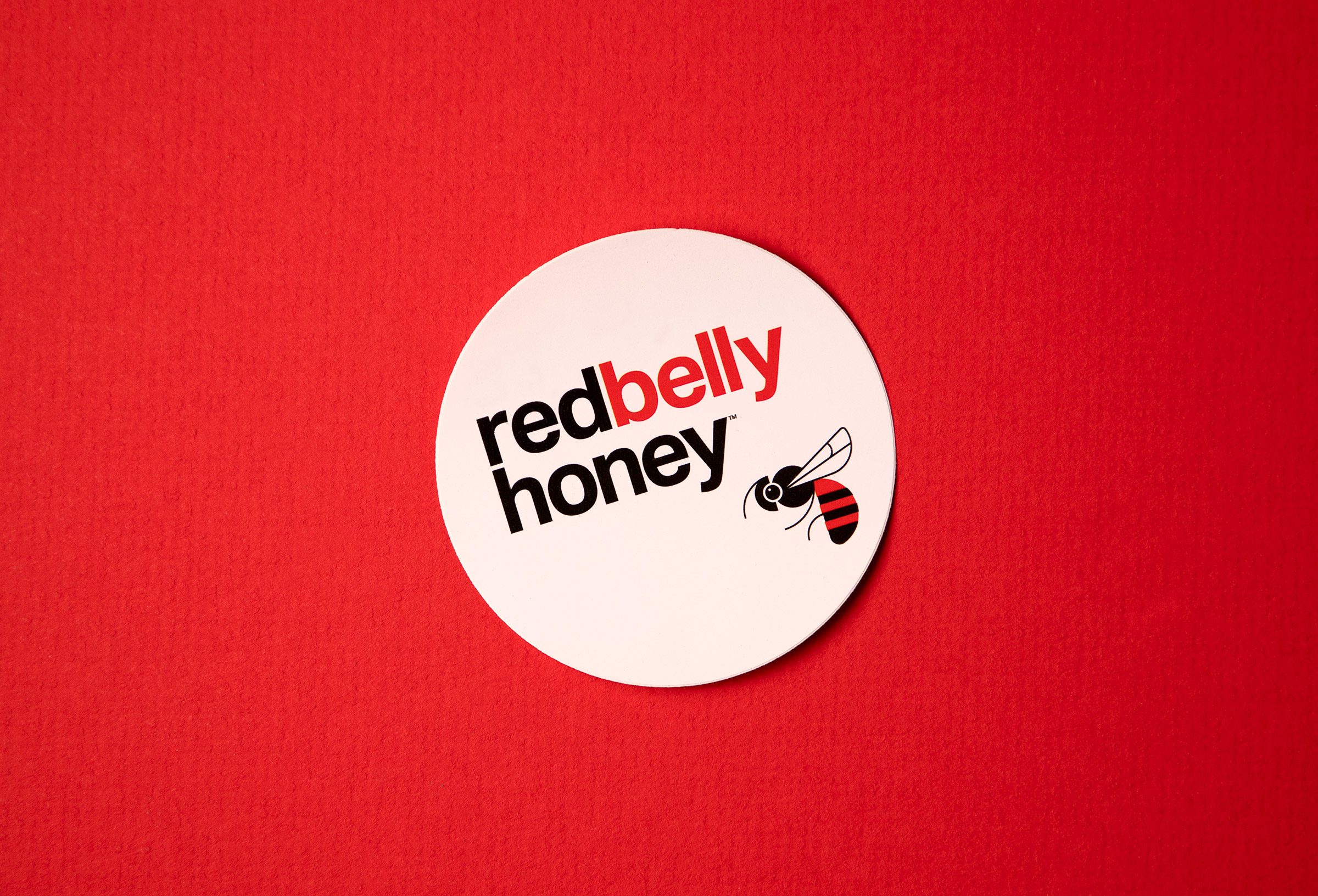 red belly honey stickers, round white on red