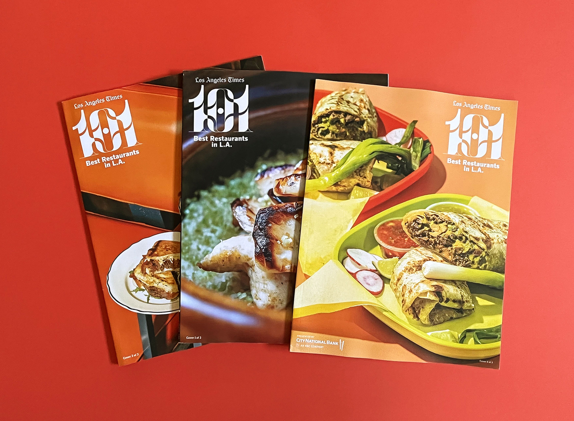 3 101 best restaurants magazines fanned out on red backdrop