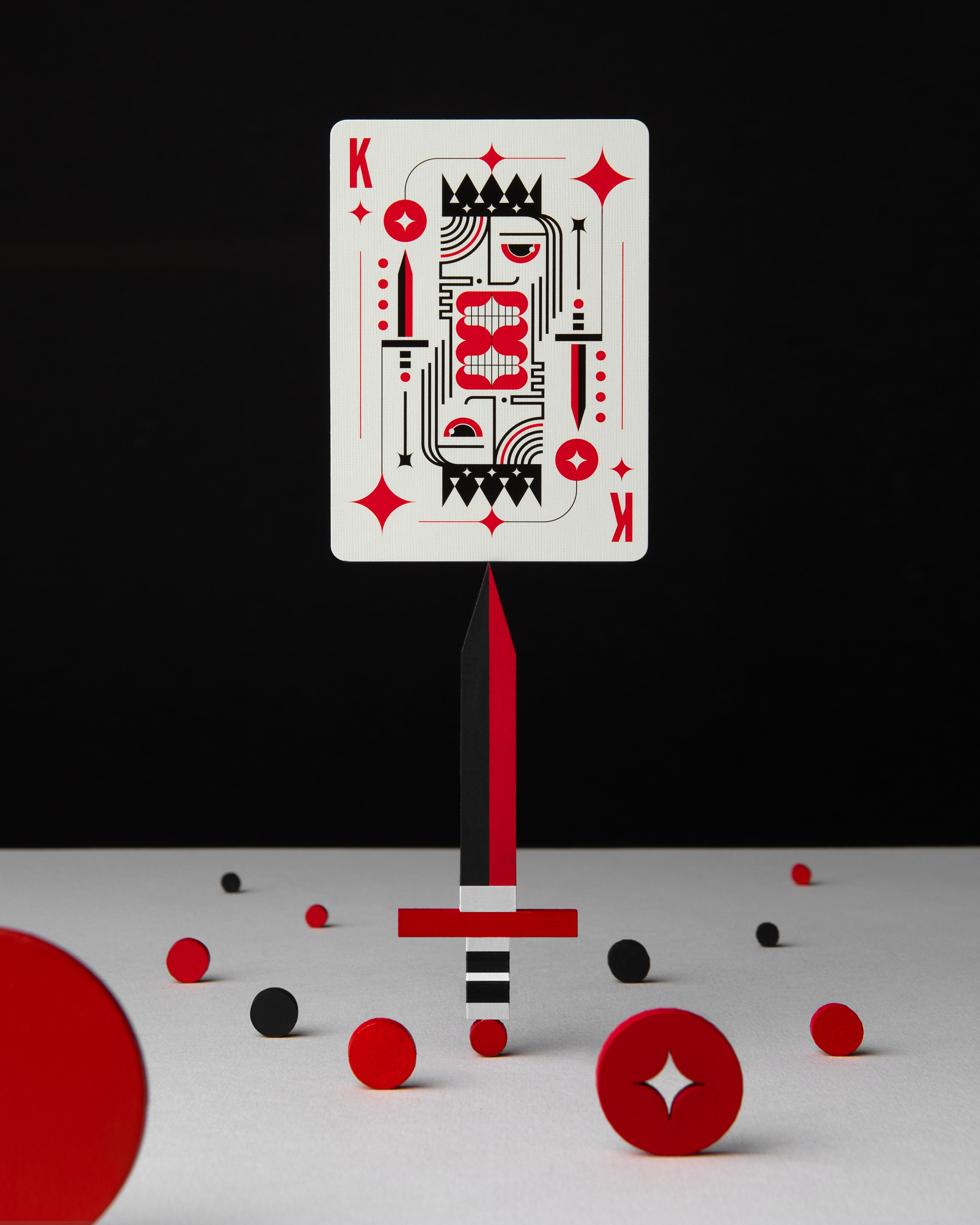 king of diamond playing card resting on a knife with circles and black background