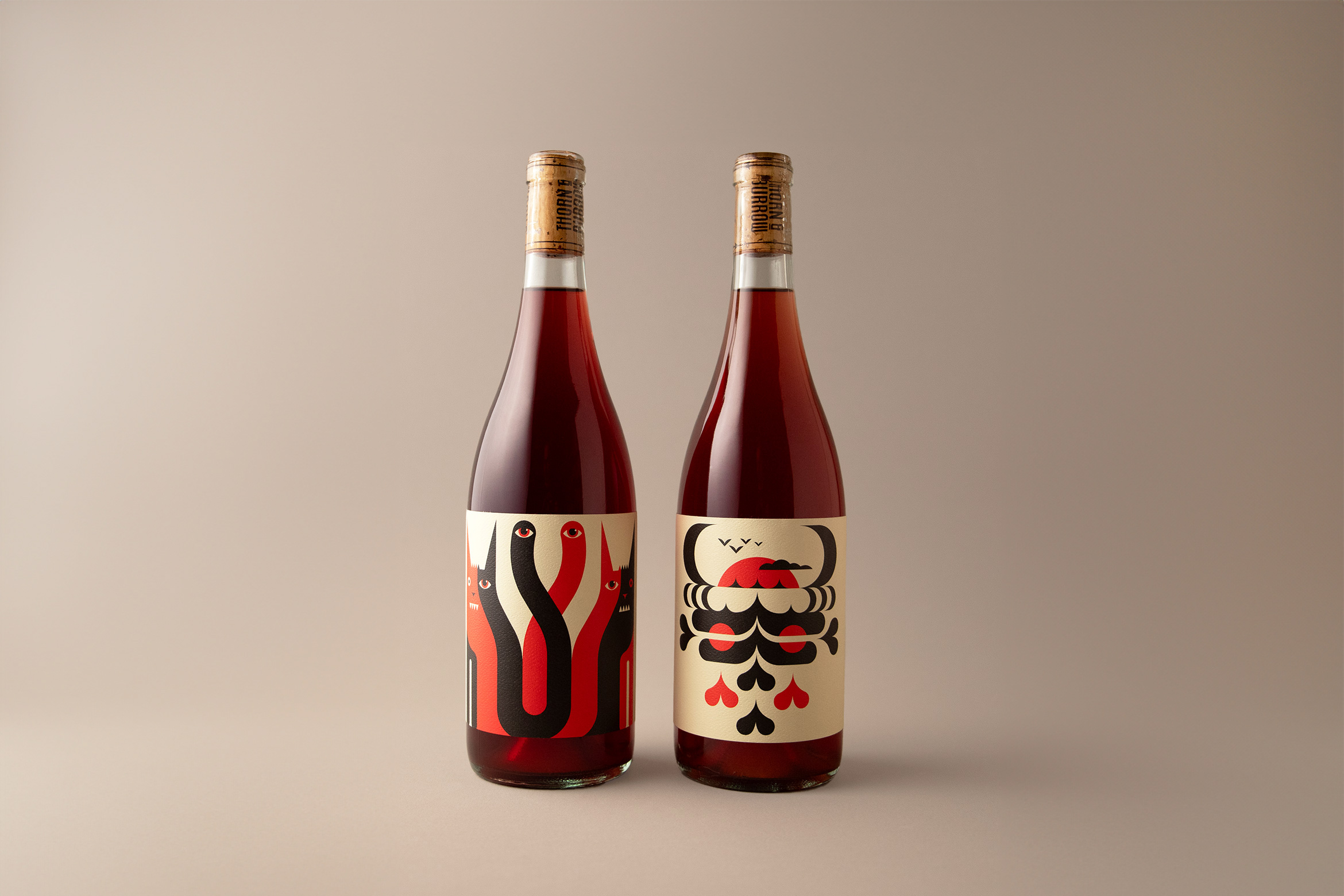 2 bottles of red wine with funky label designs