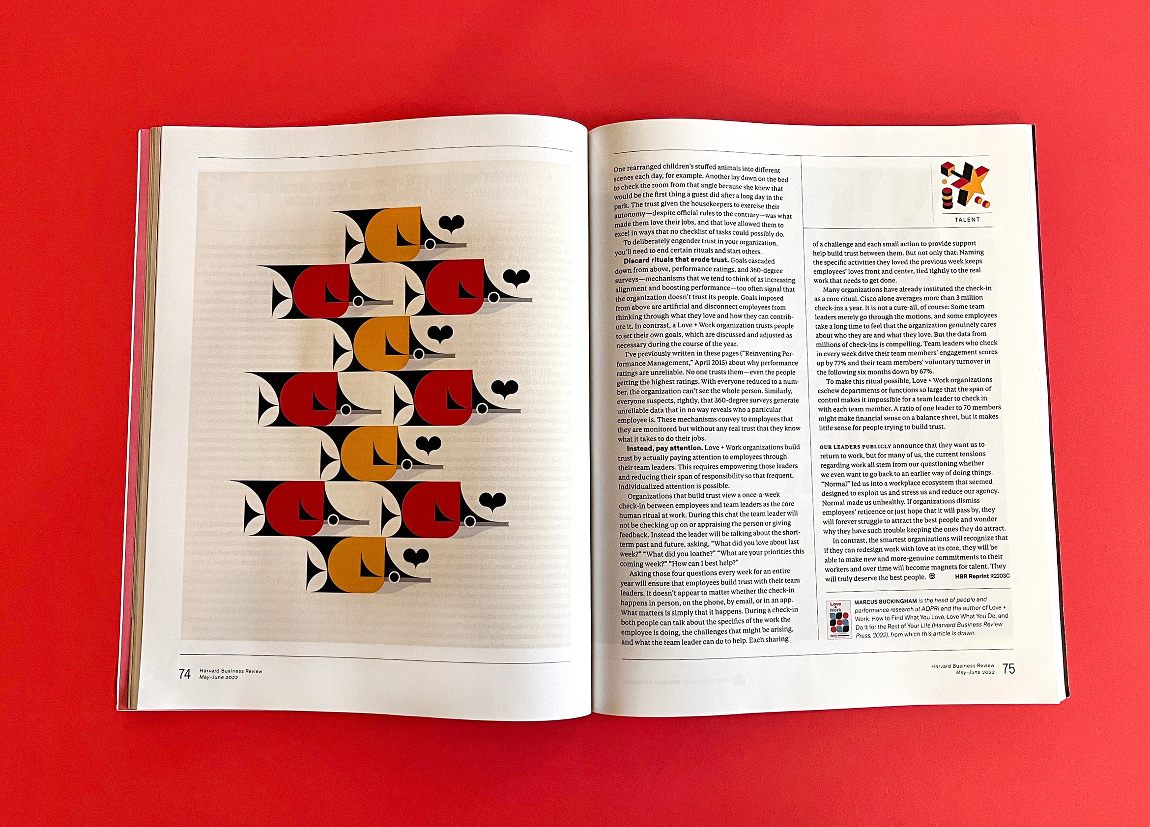 open magazine spread with school of fish artwork, black, red, yellow and cream