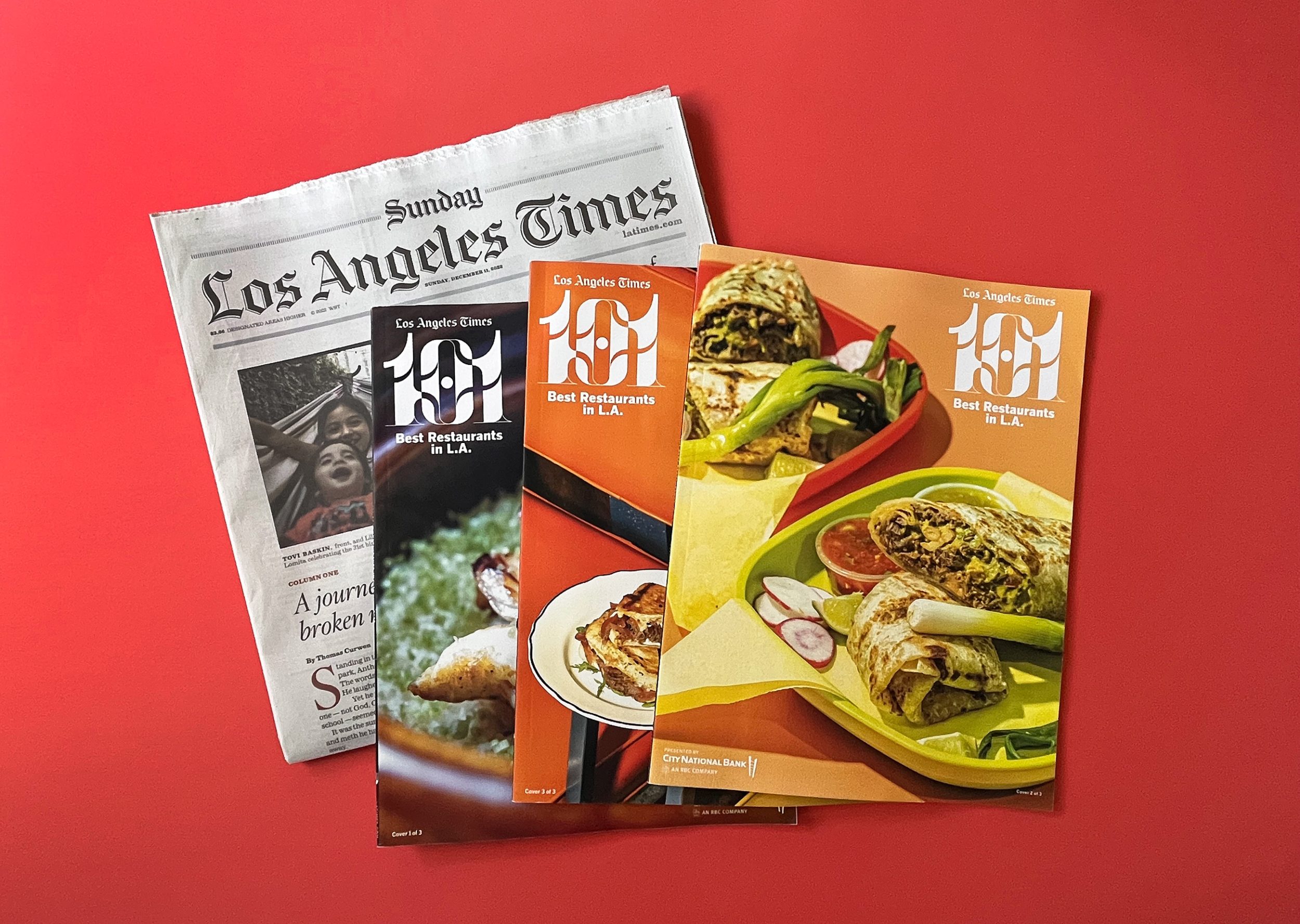 los angeles times newspaper with 3 101 best list magazines fanned out on red backdrop