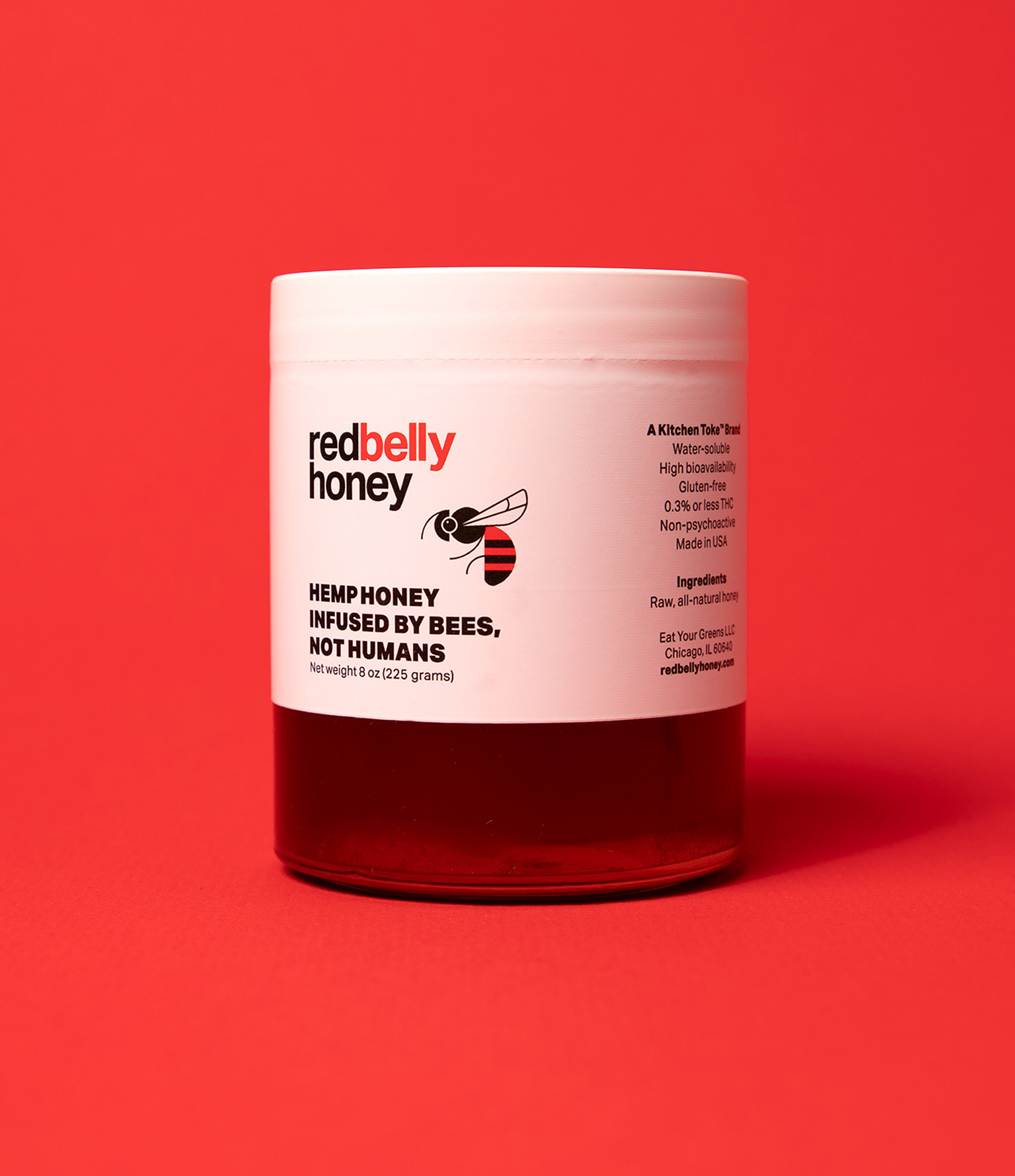 jar of red belly honey on red backdrop
